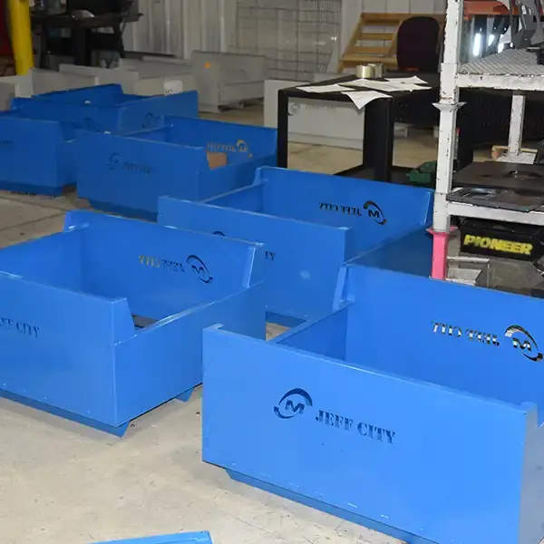 Blue returnable shipping bins for reusable industrial packaging and transport.